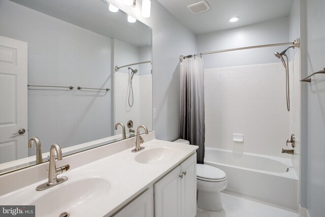 18565 Kerill Rd, Triangle, VA 22172 - full bath with shower / bath combo, toilet, double vanity, and tile patterned floors