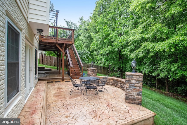 18565 Kerill Rd, Triangle, VA 22172 - view of patio featuring stairway, outdoor dining area, fence, and a deck