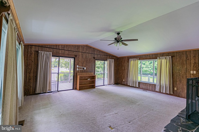 10 Mahon Cir, Ruther Glen, VA 22546 - unfurnished living room featuring wooden walls, ceiling fan, lofted ceiling, and carpet floors