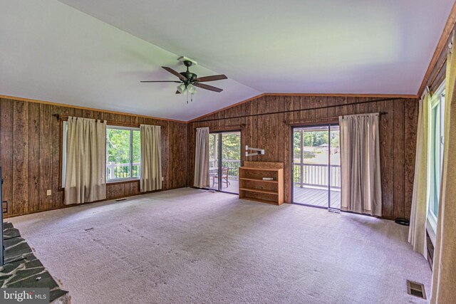 10 Mahon Cir, Ruther Glen, VA 22546 - unfurnished living room featuring vaulted ceiling, wooden walls, a ceiling fan, and carpet flooring