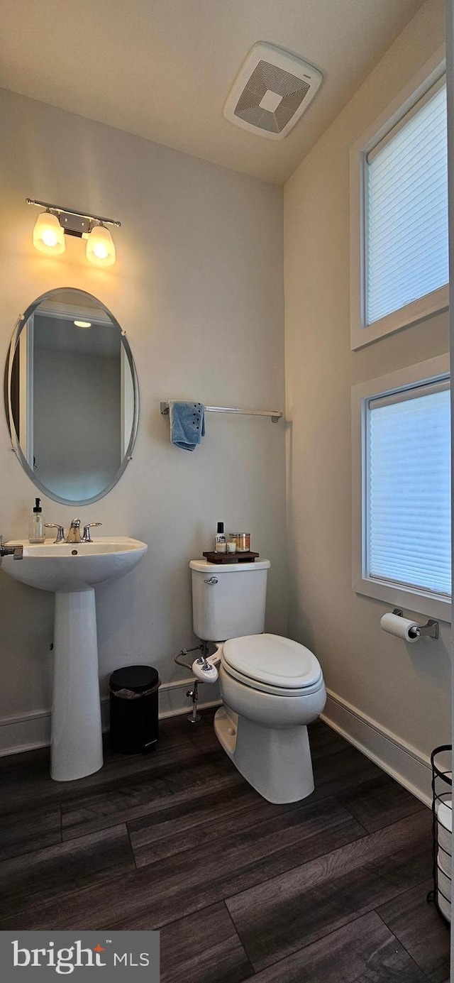21340 Rainier Ln, Broadlands, VA 20148 - half bath with wood finished floors, baseboards, toilet, and a sink