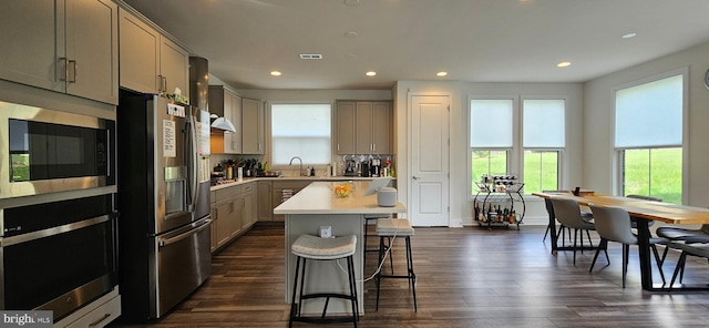 21340 Rainier Ln, Broadlands, VA 20148 - kitchen featuring appliances with stainless steel finishes, gray cabinets, a kitchen bar, light countertops, and recessed lighting