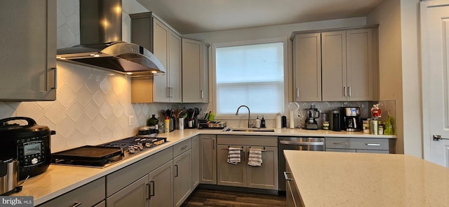 21340 Rainier Ln, Broadlands, VA 20148 - kitchen with gray cabinetry, wall chimney range hood, a sink, stainless steel appliances, and dark wood finished floors