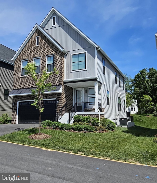 21340 Rainier Ln, Broadlands, VA 20148 - view of front of property with a front lawn, an attached garage, central air condition unit, driveway, and covered porch