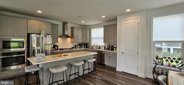 21340 Rainier Ln, Broadlands, VA 20148 - kitchen featuring stainless steel appliances, wall chimney exhaust hood, a sink, gray cabinets, and recessed lighting