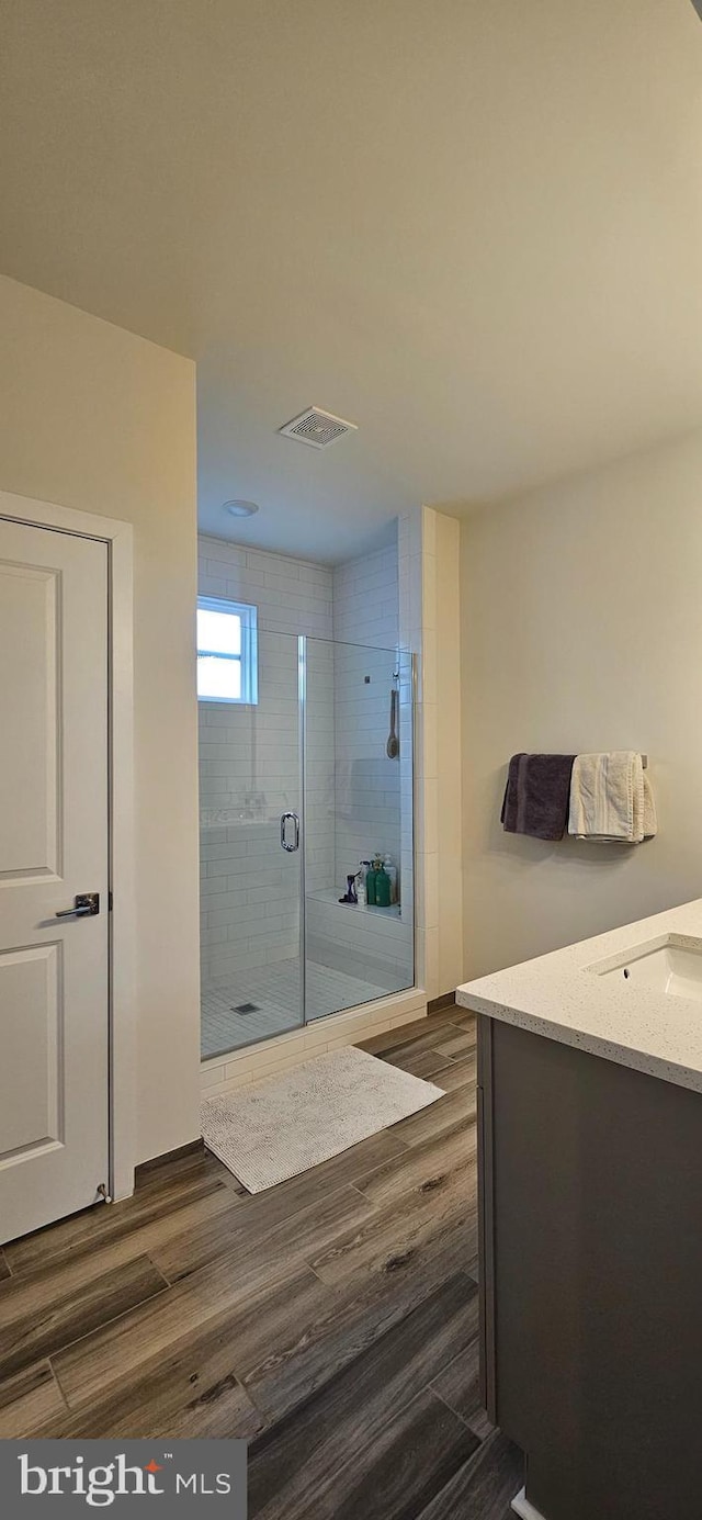 21340 Rainier Ln, Broadlands, VA 20148 - bathroom with wood finished floors, vanity, and a shower stall