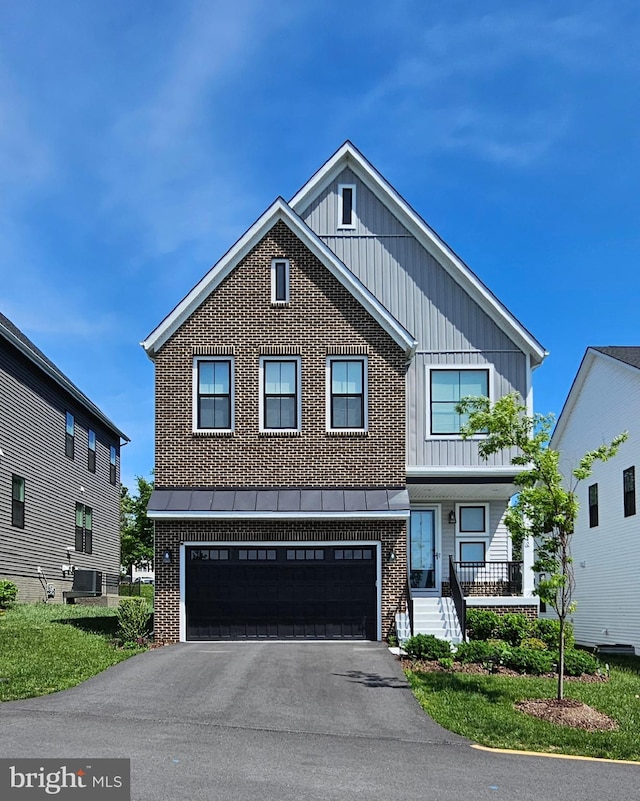 21340 Rainier Ln, Broadlands, VA 20148 - view of front of home with brick siding, board and batten siding, a garage, and driveway