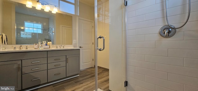 21340 Rainier Ln, Broadlands, VA 20148 - bathroom with a shower stall, double vanity, and wood finished floors
