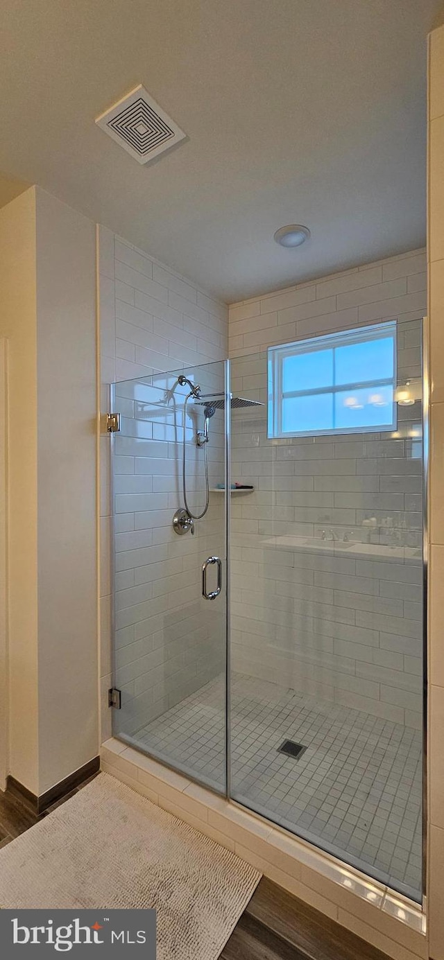 21340 Rainier Ln, Broadlands, VA 20148 - full bathroom featuring a shower stall, baseboards, and wood finished floors