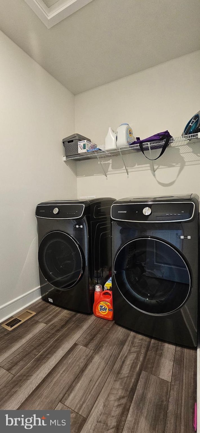 21340 Rainier Ln, Broadlands, VA 20148 - laundry area featuring wood finished floors, washing machine and clothes dryer, and baseboards