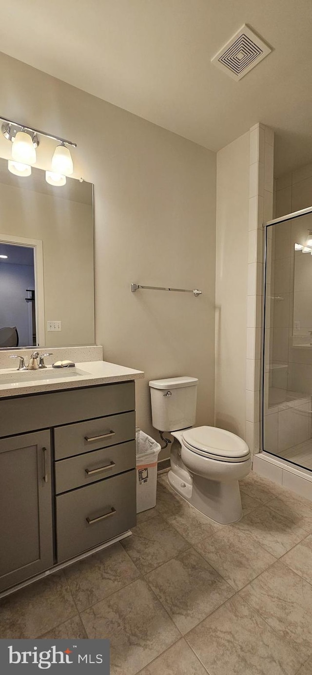 21340 Rainier Ln, Broadlands, VA 20148 - bathroom featuring toilet, vanity, a stall shower, and tile patterned flooring