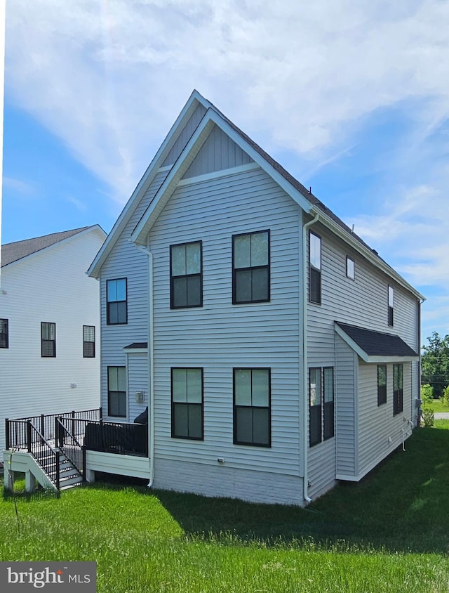 21340 Rainier Ln, Broadlands, VA 20148 - rear view of property featuring a lawn and board and batten siding