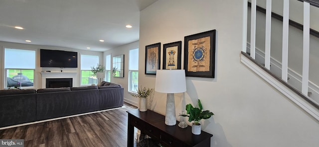 21340 Rainier Ln, Broadlands, VA 20148 - living area with healthy amount of natural light, wood finished floors, recessed lighting, a fireplace, and stairs