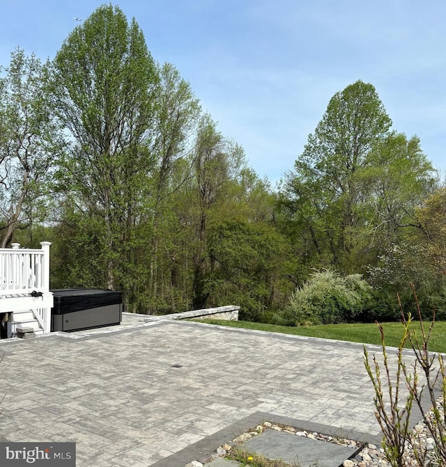 view of patio / terrace with a hot tub