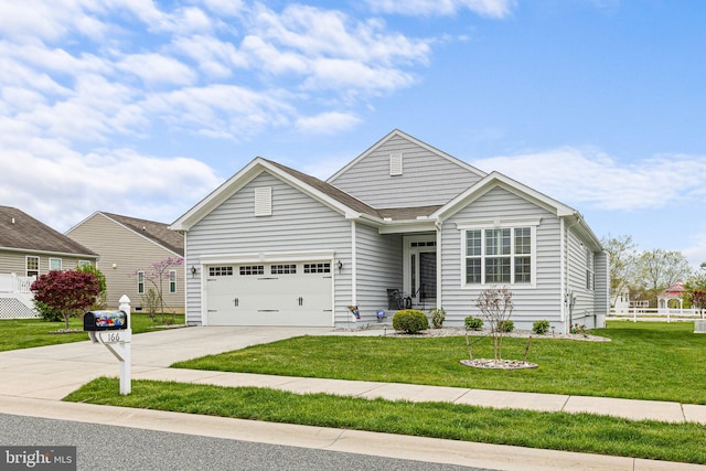 view of front of house featuring fence, concrete driveway, a front yard, and a garage