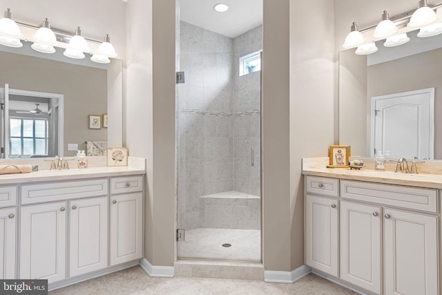 full bathroom featuring a sink, a shower stall, and baseboards