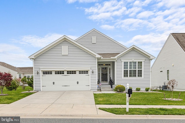 single story home featuring a front lawn, driveway, and a garage
