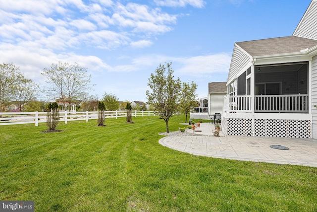 view of yard featuring a patio, fence, and a sunroom