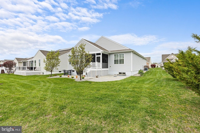 back of house featuring a sunroom, a yard, and a patio area