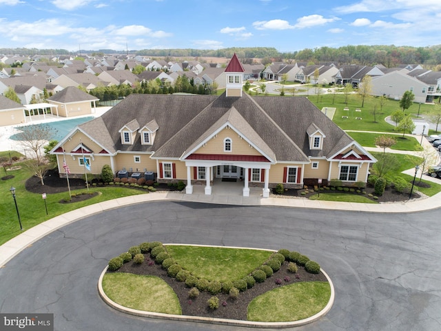 view of property featuring curved driveway and a residential view