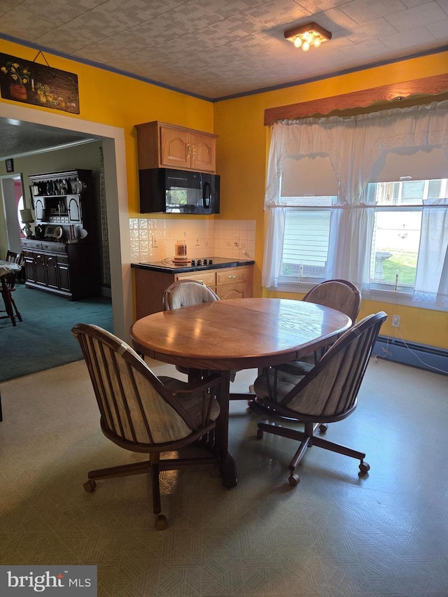 dining room with baseboard heating and carpet