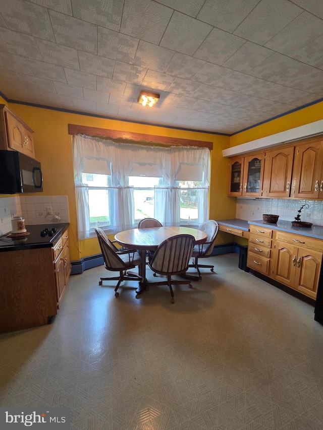 dining area featuring a baseboard radiator and plenty of natural light