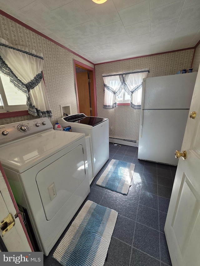 laundry area with laundry area, crown molding, baseboard heating, wallpapered walls, and washer and clothes dryer