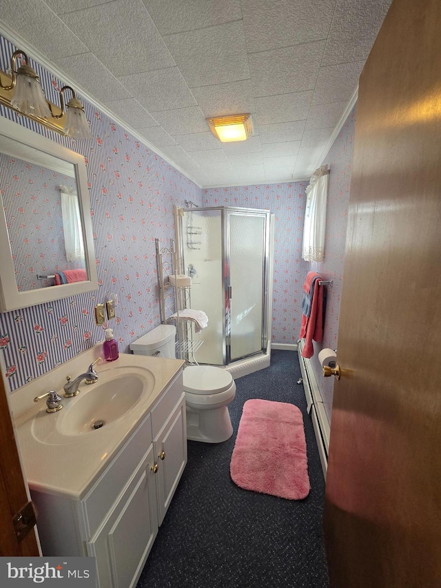 bathroom featuring a stall shower, vanity, a baseboard radiator, toilet, and wallpapered walls