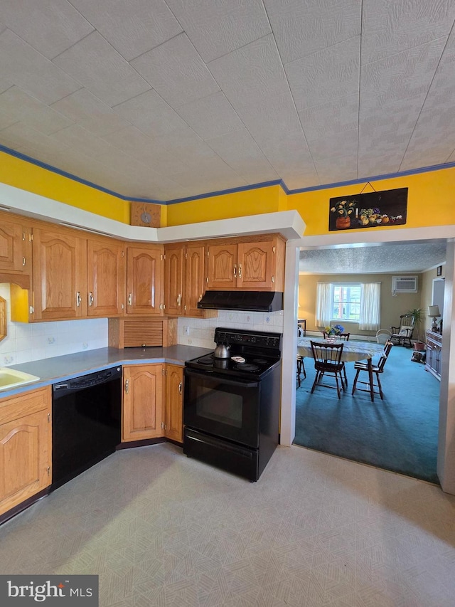kitchen with decorative backsplash, brown cabinets, a sink, black appliances, and under cabinet range hood