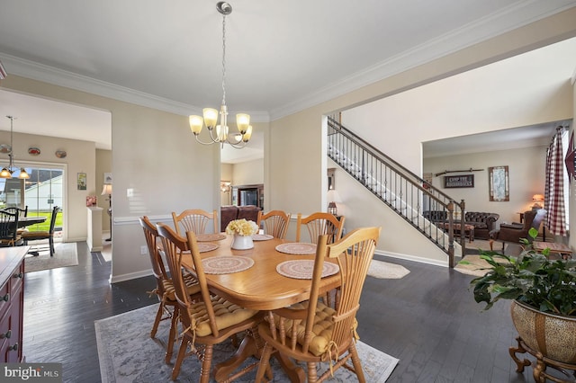 40 Mannings Ct, Smyrna, DE 19977 - dining room featuring crown molding, baseboards, an inviting chandelier, stairs, and dark wood-type flooring