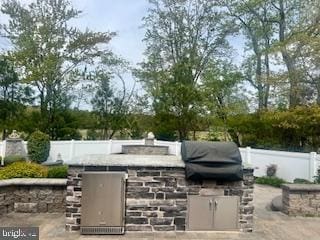 view of patio / terrace featuring area for grilling, fence, and grilling area