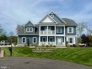 view of front of property with a porch, a front lawn, and a balcony