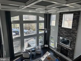 interior space featuring coffered ceiling, dark wood-style flooring, and beamed ceiling