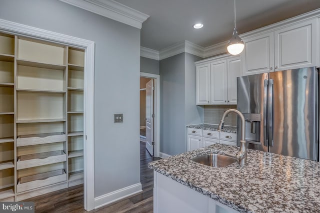 30780 Lindell Ln, Frankford, DE 19945 - kitchen with baseboards, stone countertops, a sink, and stainless steel fridge with ice dispenser