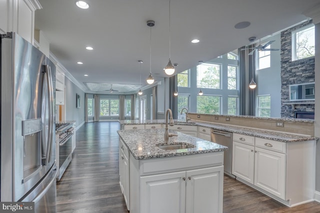 30780 Lindell Ln, Frankford, DE 19945 - kitchen featuring a sink, a kitchen island with sink, open floor plan, a ceiling fan, and appliances with stainless steel finishes