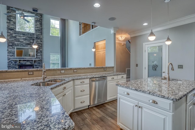 30780 Lindell Ln, Frankford, DE 19945 - kitchen with stainless steel dishwasher, a sink, dark wood-style flooring, and white cabinetry
