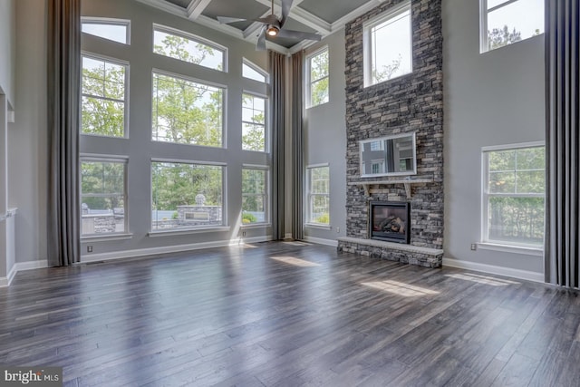 30780 Lindell Ln, Frankford, DE 19945 - unfurnished living room with a towering ceiling, a fireplace, beamed ceiling, baseboards, and dark wood finished floors