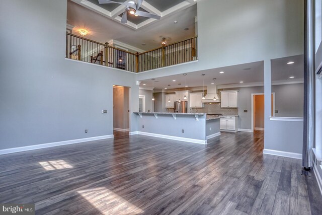 30780 Lindell Ln, Frankford, DE 19945 - unfurnished living room featuring crown molding, a towering ceiling, baseboards, dark wood-style floors, and a ceiling fan