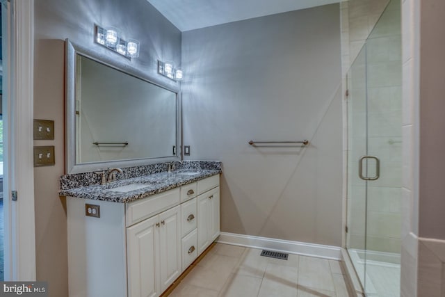 30780 Lindell Ln, Frankford, DE 19945 - full bathroom with double vanity, visible vents, a shower stall, and a sink