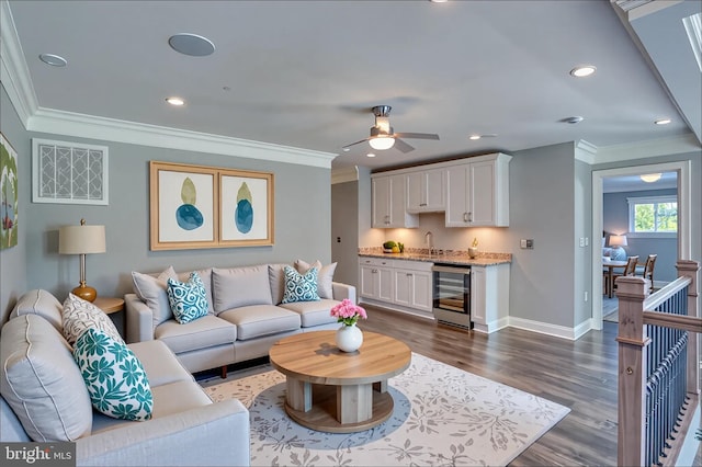 30780 Lindell Ln, Frankford, DE 19945 - living area with ornamental molding, dark wood-style flooring, beverage cooler, baseboards, and a ceiling fan
