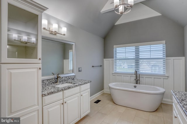 30780 Lindell Ln, Frankford, DE 19945 - bathroom featuring a freestanding bath, wainscoting, tile patterned flooring, vanity, and lofted ceiling