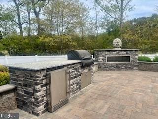 view of patio featuring a grill and an outdoor kitchen
