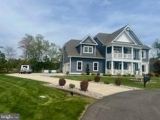 30780 Lindell Ln, Frankford, DE 19945 - view of front facade featuring driveway, a balcony, and a front yard