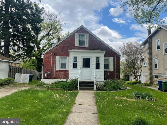 bungalow featuring a front yard, fence, entry steps, and brick siding