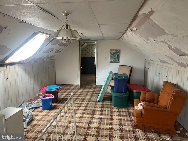 additional living space with wood walls and lofted ceiling