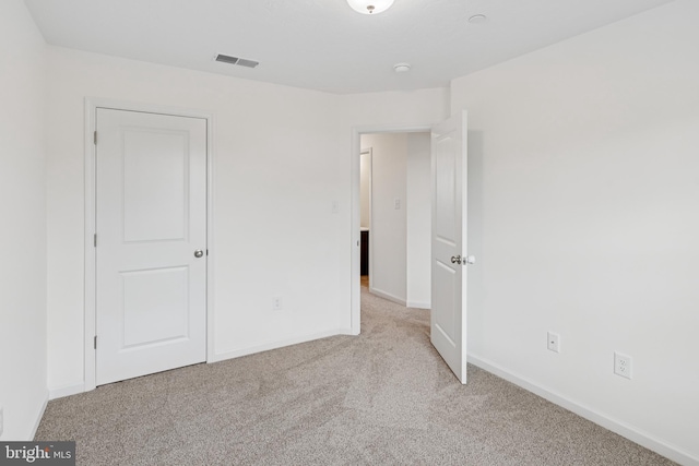 199 Holstein Dr Unit 117, Hanover, PA 17331 - unfurnished bedroom featuring visible vents, baseboards, and light carpet