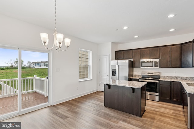 199 Holstein Dr Unit 117, Hanover, PA 17331 - kitchen featuring a kitchen island, dark brown cabinets, a notable chandelier, stainless steel appliances, and light wood-style flooring