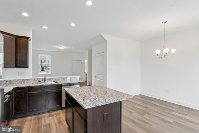 199 Holstein Dr Unit 117, Hanover, PA 17331 - kitchen with dark brown cabinets, a sink, dishwasher, a chandelier, and light wood-type flooring
