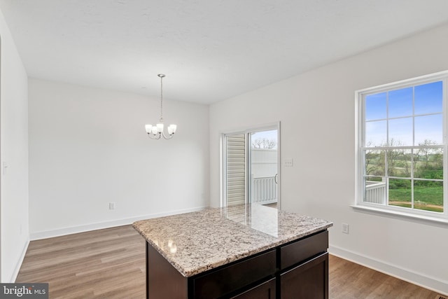 199 Holstein Dr Unit 117, Hanover, PA 17331 - unfurnished dining area with baseboards, a chandelier, a healthy amount of sunlight, and light wood finished floors