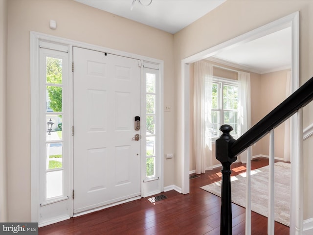 2322 Golden Chapel Rd, Odenton, MD 21113 - foyer entrance featuring baseboards, crown molding, dark wood-style floors, and visible vents